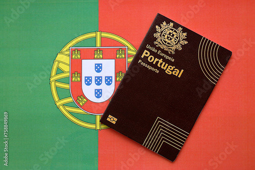 Red Portugal passport of European Union on national flag background close up. Tourism and citizenship concept
