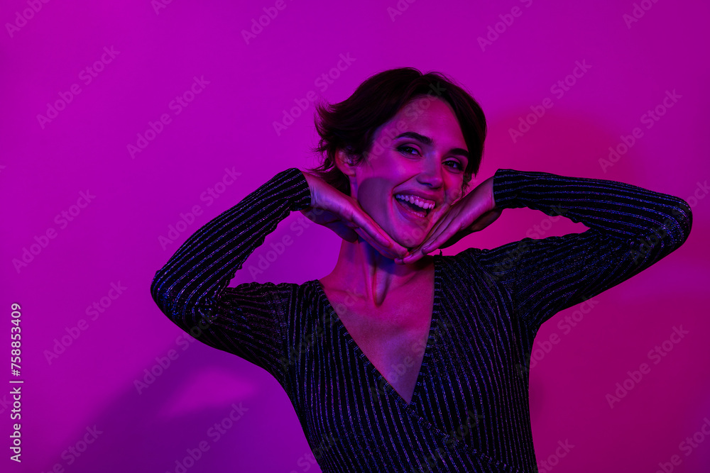 Photo portrait of lovely young lady frame face laugh dressed stylish overall garment isolated on neon light pink color background Photo portrait of lovely young lady frame face laugh dressed stylish overall garment isolated on neon light pink color background
