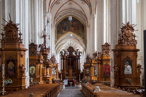 VILNIUS, LITHUANIA - JUNE 15 2023: Interior of the chapel in the Church of St. Francis and St. Bernard with vaulted ceiling and richly decorated Jesus Christ Cross