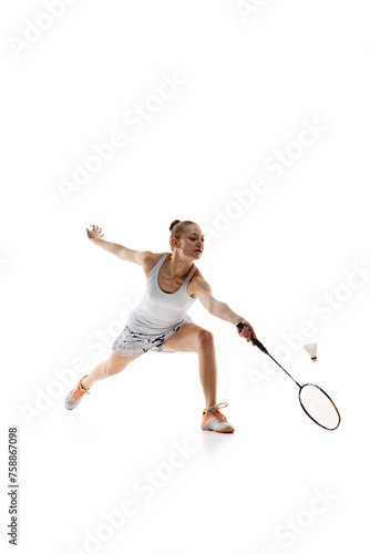 Concentrated young girl, athlete in motion with racket, playing badminton isolated over white background. Training. Concept of professional sport, active lifestyle, hobby, game © master1305