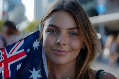 young woman holding national flag of Austraia on street photo