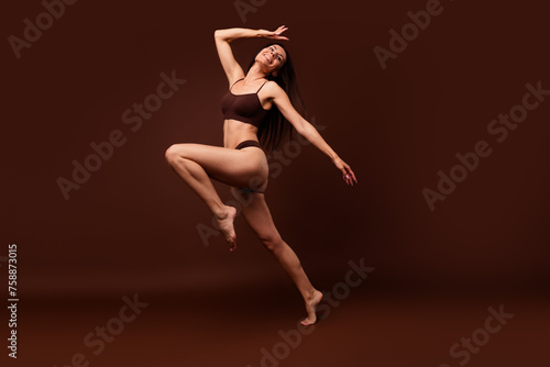 No retouch full body photo of adorable stunning woman wear lingerie look at promo empty space run isolated on dark brown color background