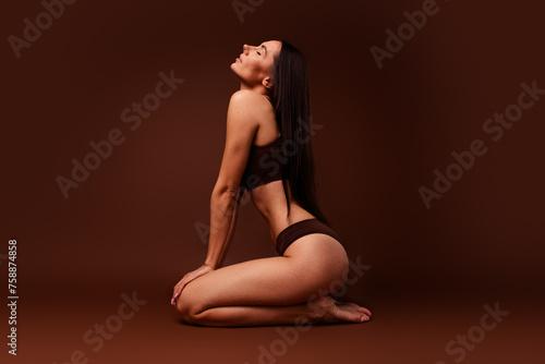 Full body photo no retouch of pretty young girl sit floor body positive dressed stylish underwear isolated on brown color background