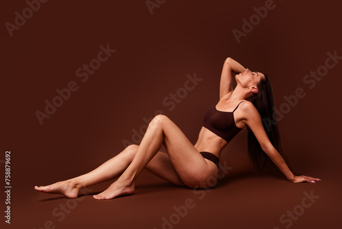 Full body photo no filter of pretty young girl sit floor teasing pose stunning dressed stylish underwear isolated on brown color background