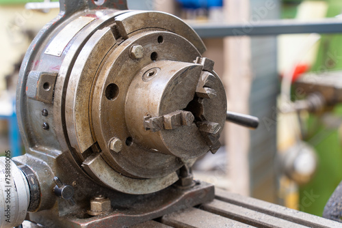A metal disc part of a metalworking milling machine in a workshop