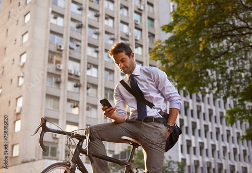 Bicycle, businessman and smartphone for sustainable travel, transportation and communication in city. Cellphone, commute and male employee on bike for cycling, carbon neutral or texting in urban town