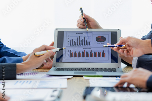 Meeting in the office Teamwork with cost analysis graph, business people on table at conference room