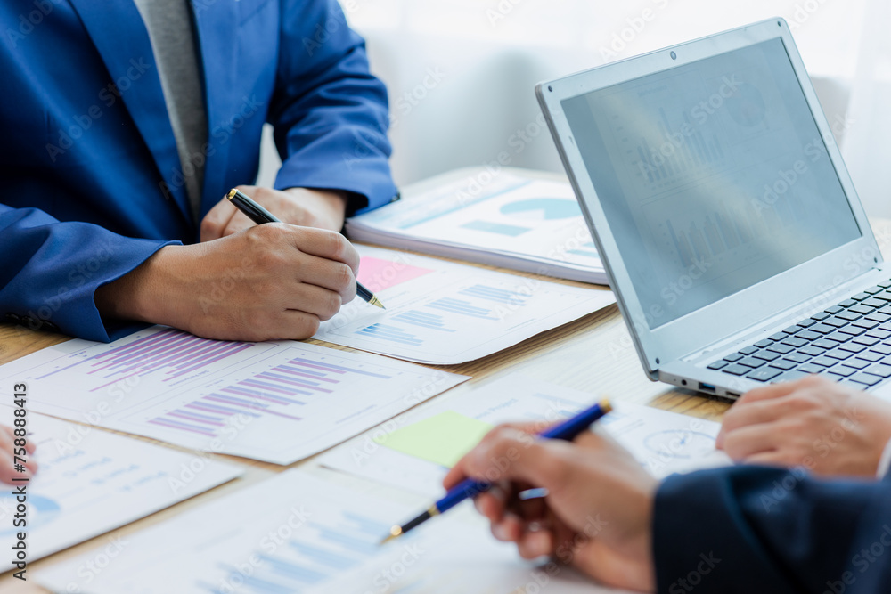 Meeting in the office Teamwork with cost analysis graph, business people on table at conference room Meeting in the office Teamwork with cost analysis graph, business people on table at conference room