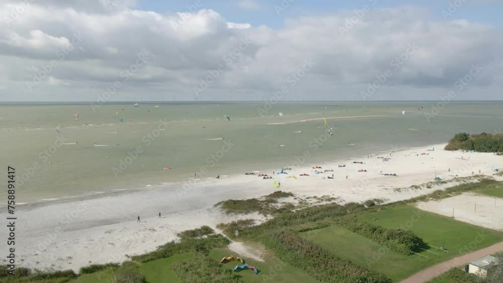 Aerial view of people doing kite surfing along the beach sunny day, Netherlands Aerial view of people doing kite surfing along the beach sunny day, Netherlands