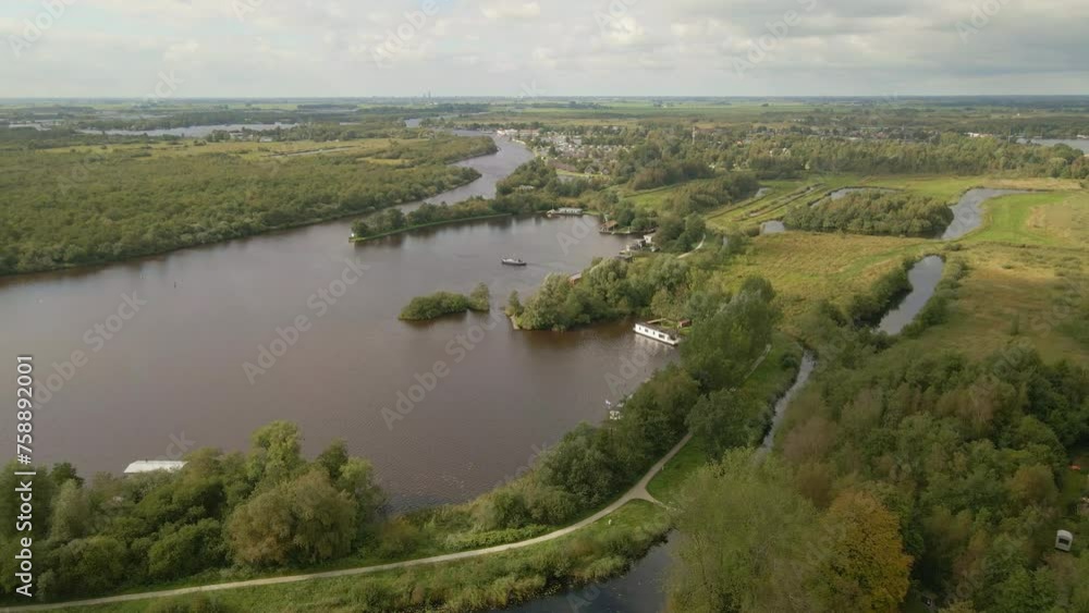 Aerial view of boat cruising on lake at cloudy day, De Alde Feanen, Earnewald, Friesland, Netherlands Aerial view of boat cruising on lake at cloudy day, De Alde Feanen, Earnewald, Friesland, Netherlands