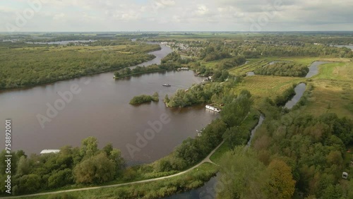 Aerial view of boat cruising on lake at cloudy day, De Alde Feanen, Earnewald, Friesland, Netherlands photo