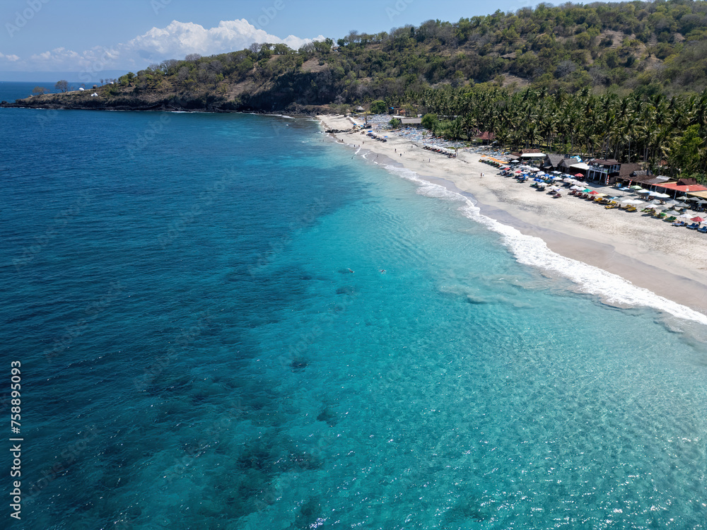 Bay with hotel complex, sea, beach and boats in Bali, drone photo