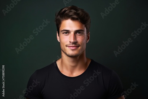 Portrait of a handsome young man on dark background. Men's beauty, fashion. © Loli