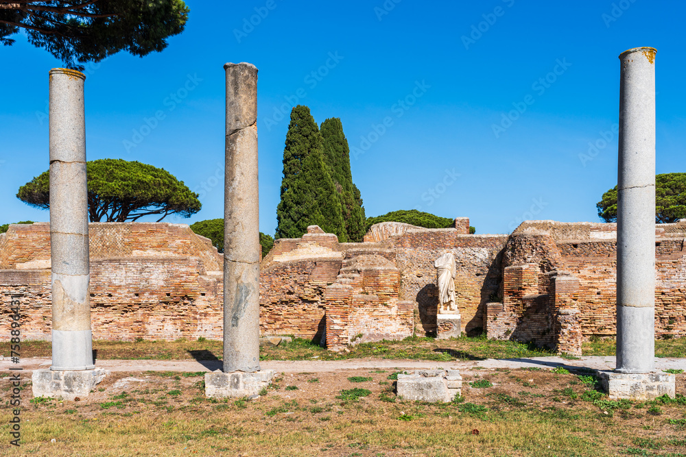 Sequence of three pillars in ruins in ancient Ostia archaeological park in Italy