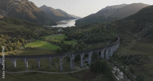 Aerial view of Glenfiddich Viaduct over the tranquil river and beautiful greenery, Scotland, United Kingdom. photo