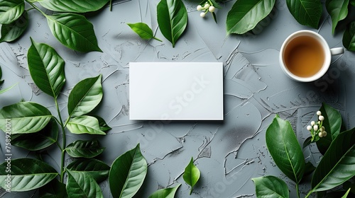 Mockup of blank business cards, cup of tea and leaves