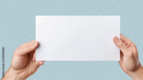 A person holding a piece of paper. Suitable for various concepts