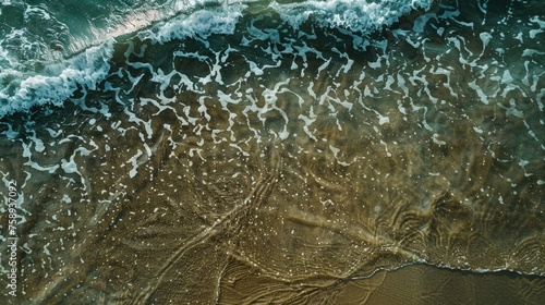 Aerial view of sandy beach with waves, suitable for travel brochures