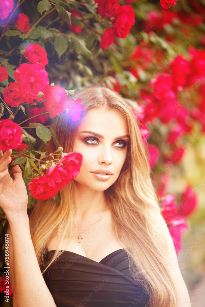 Beautiful fashionable woman with red lips makeup posing outdoor, in blooming rose garden. Beautiful fashionable woman with red lips makeup posing outdoor, in blooming rose garden.