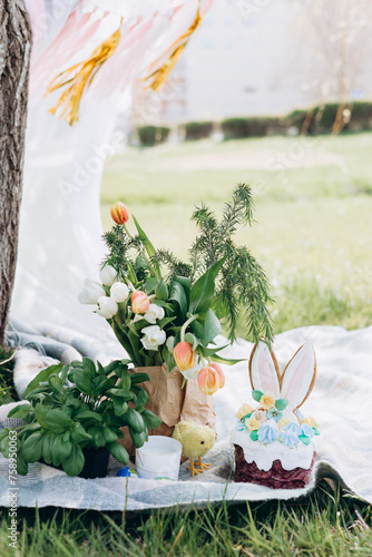 Easter celebration, Child in nature with Easter cake and eggs and Easter decor photo