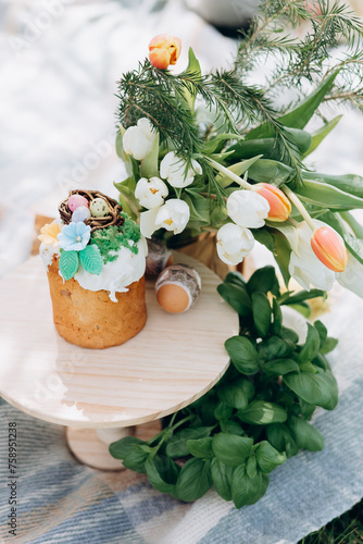 Easter celebration, Child in nature with Easter cake and eggs and Easter decor photo