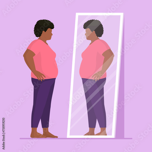 Plus size woman looking at herself in a mirror