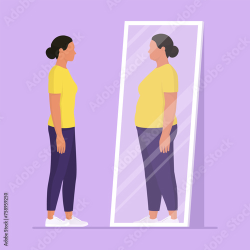 Woman looking at the mirror and seeing herself as overweight