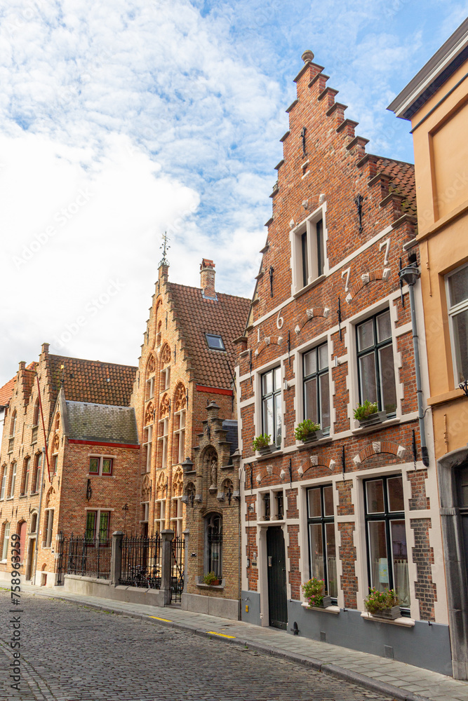 Street with old medieval houses. The facades are built with stepped pediments.. Bruges. Flanders. Belgium.