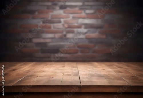 Empty wooden table surface with a blurred brick wall in the background