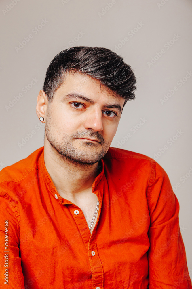 Fototapeta premium Serious man portrait real people high definition grey background. Serious looking young man portrait
