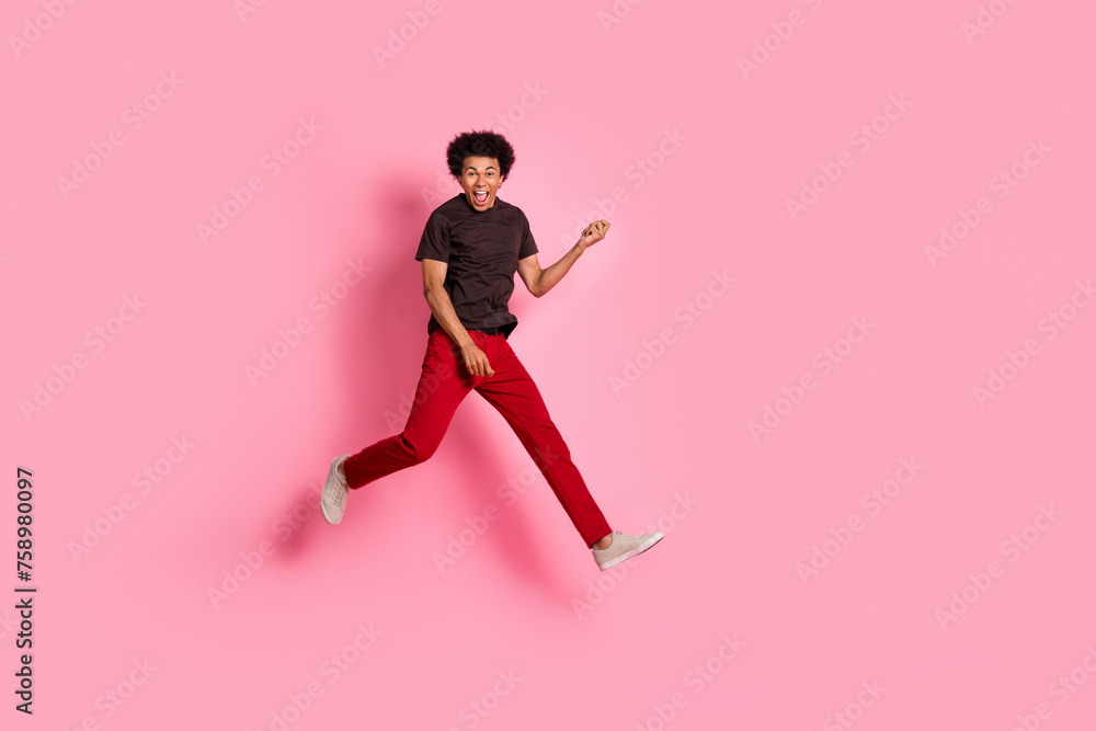 Full body length photo of hipster guy jumping holding solo electro guitar musician rock roll concert isolated on pink color background