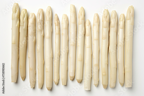 A neat row of white asparagus spears aligned on a white background, highlighting their pale, creamy texture and delicate tips.