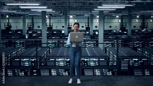 Full Body Of Asian Business Woman Using Laptop Computer In Data Center photo
