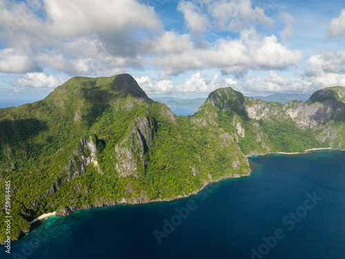 Cadlao Island surrounded by blue sea. Blue sky and clouds. El Nido, Philippines.