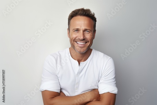 Portrait of handsome middle aged man in white t-shirt.