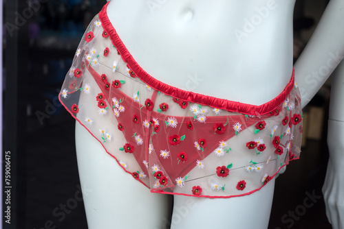 Closeup of red printed flowers on cheeky on mannequin in a fashion store showroom