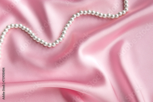 Pearls on silk background with space for message