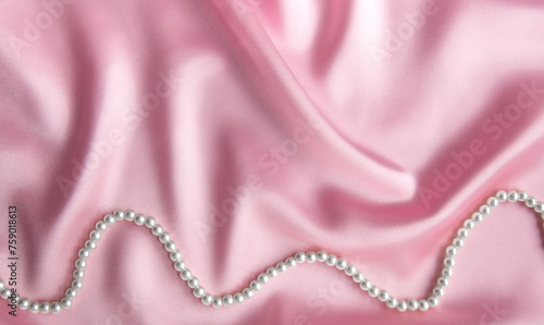 Pearls on silk background with space for message