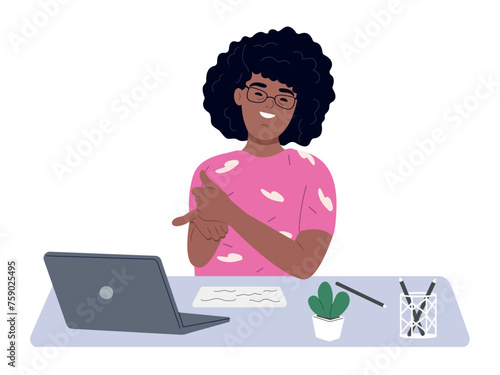 Person with Down syndrome sits at a desk uses a laptop. A woman with Down syndrome works with a laptop in the office. Social integration concept.