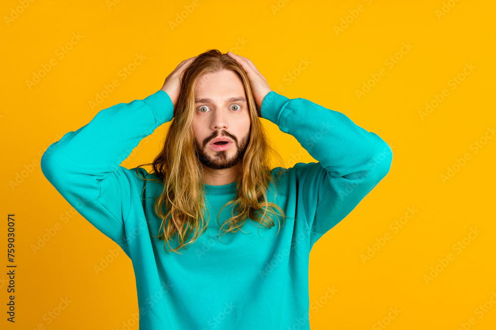 Portrait of speechless worried person arms touch head cant believe empty space isolated on yellow color background - obrazy, fototapety, plakaty 