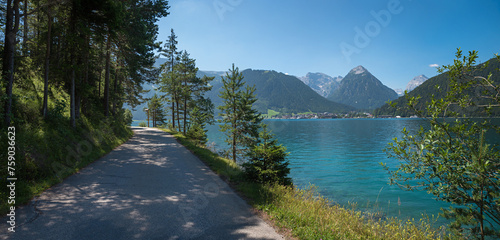 bike and walkway along lake Achensee, view to Pertisau tourist resort and karwendel alps