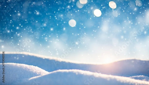 winter snow background with snowdrifts with beautiful light and snow flakes on the blue sky in the evening banner format copy space © Susan