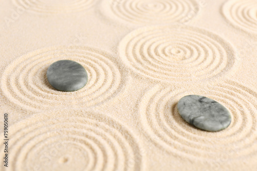 Zen garden stones on beige sand with pattern