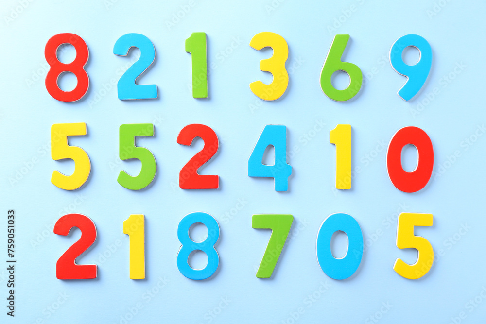 Colorful numbers on light blue background, flat lay Colorful numbers on light blue background, flat lay
