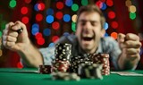 Very happy man winning money in casino.