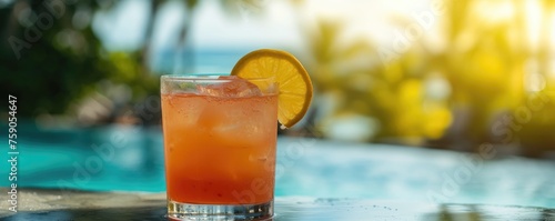 Cocktail drink at sunset beach in background.