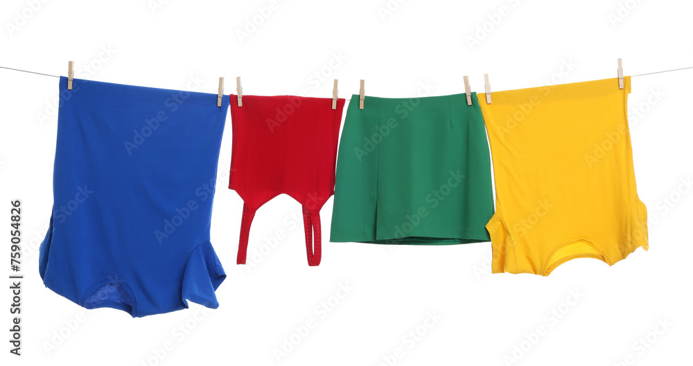 Different clothes drying on laundry line against white background