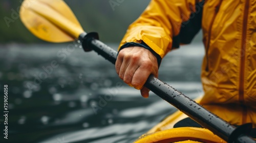 Adventurer in a yellow raincoat kayaking in tranquil waters during a rainfall, evoking a sense of exploration