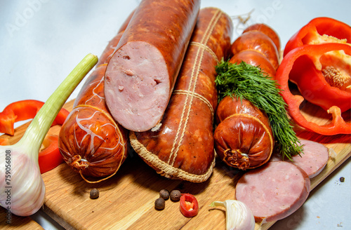 Tasty sausages and vegetables isolated over solid background