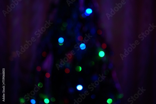 Christmas blurred background. A luminous Christmas tree garland. Christmas decorations.